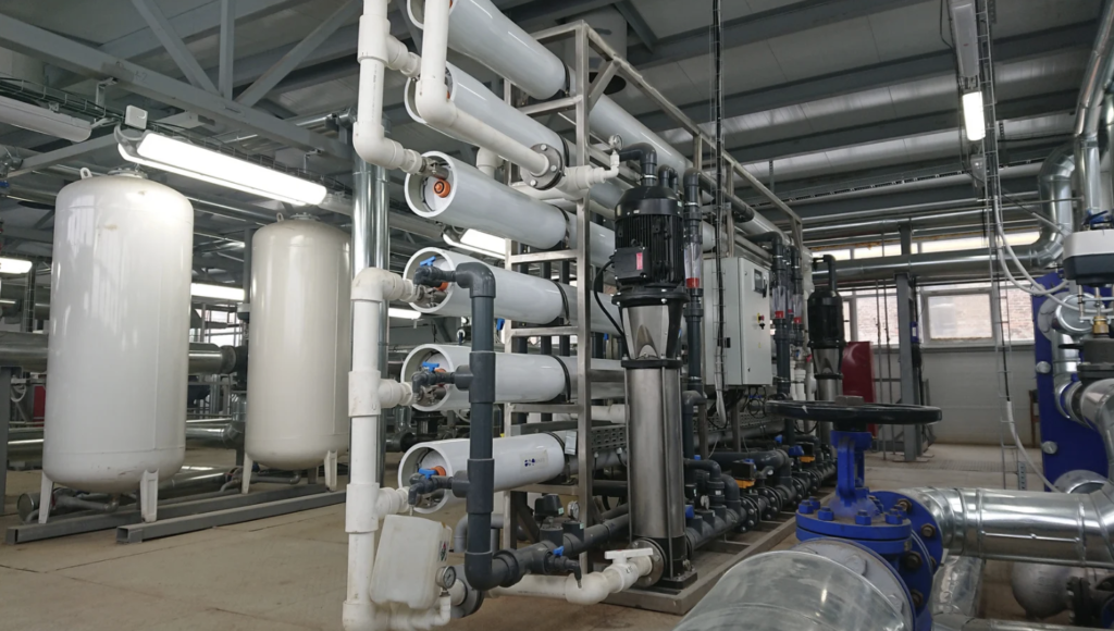 Industrial water treatment system with reverse osmosis units, piping, and filtration equipment, illustrating water chemistry control, dissolved substances removal, and temperature management in industrial systems