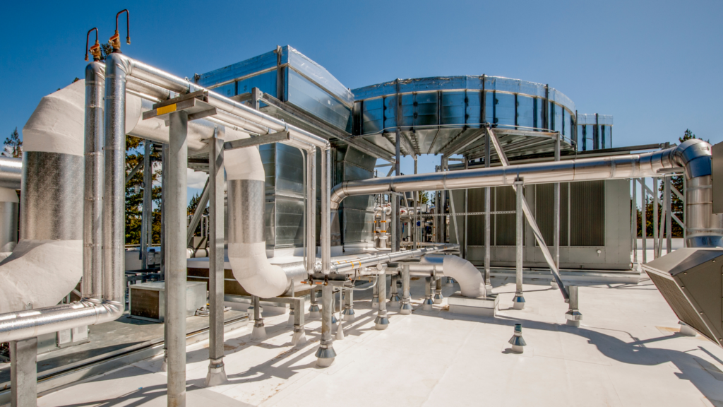 Insulated rooftop piping and equipment in a closed loop glycol cooling system on a commercial building.