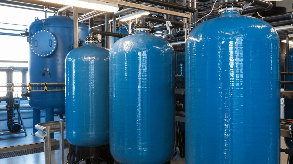 Industrial water softener system with resin tank, brine tank, and control valve connected to plumbing and pipes, supporting water softening and filtration systems to improve water quality, reduce hardness minerals, prevent scale buildup, and maintain high quality water through efficient ion exchange and regeneration cycles.