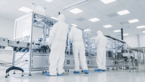Personnel in a sterile cleanroom operating automated equipment, emphasizing the importance of water quality for sterilization effectiveness.