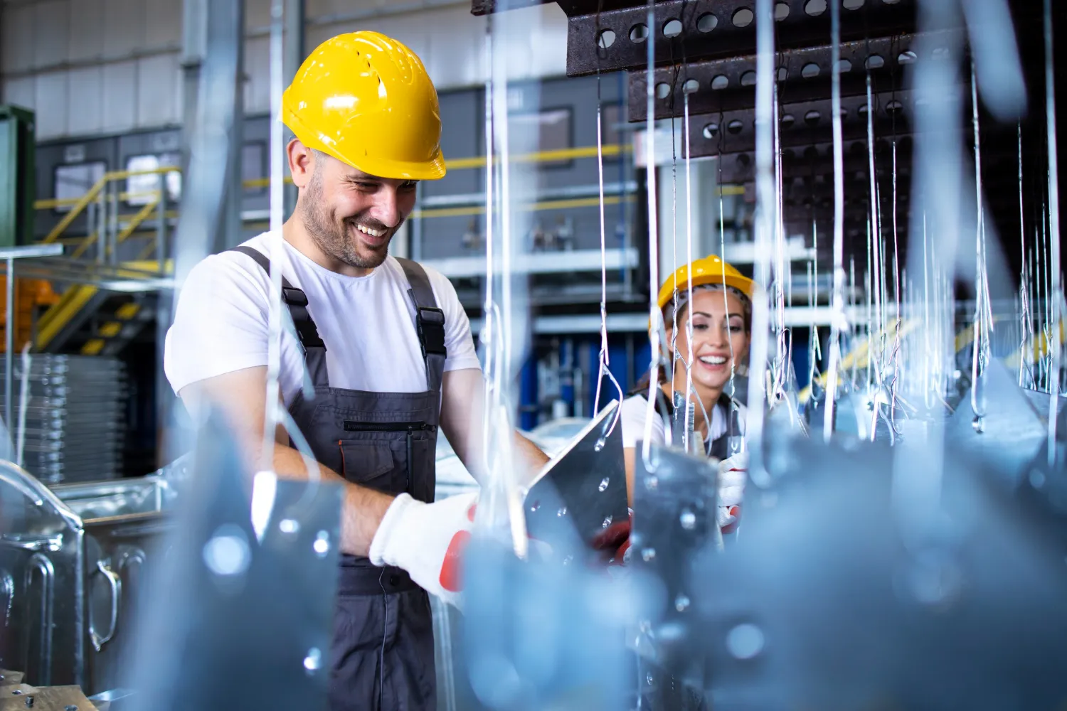 Industrial water treatment technicians inspecting water treatment equipment and process systems inside a commercial facility.